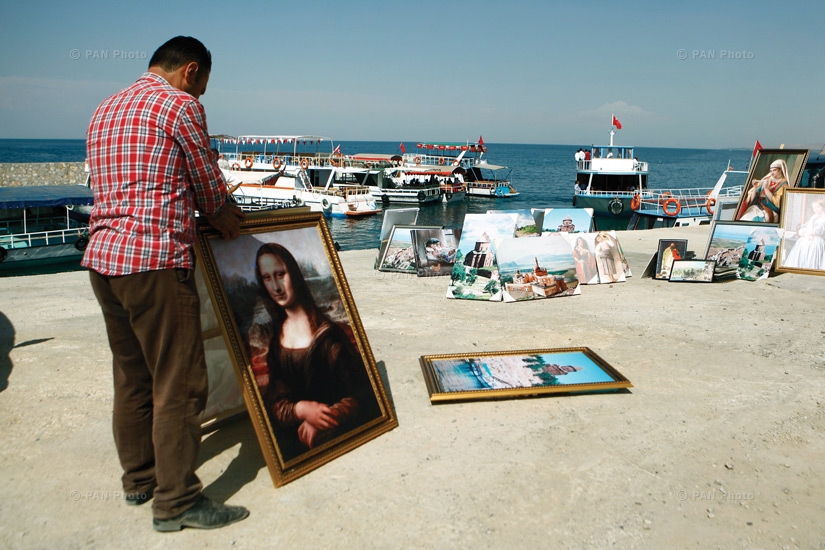 A painter sells his work on the shore of Lake Van. Tourists often visit this region and buy souvenirs from the locals
