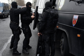 French police release 18 hostages at store, hunt attackers
