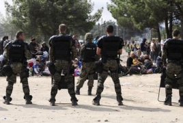 Macedonian police fire stun grenades to disperse thousands of migrants