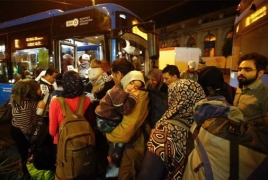 Buses take migrants to Austria as Hungary gives in to crowds
