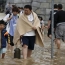 Over 100,000 flee as Japan rivers burst their banks