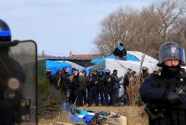 Work begins to clear part of Calais migrant camp in France