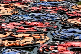 Chinese artist Ai Weiwei's refugee life jackets in Vienna palace pond