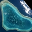 China to build on shoal in disputed South China Sea