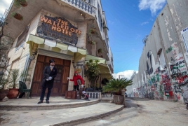 Banksy's Walled-Off Hotel in West Bank opens doors to first guests