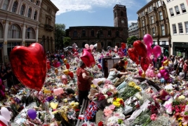 UK lowers security threat level as police close on bomber's network