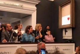 Banksy shreds his own painting after it sells for £1m