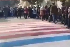 Tehran students refuse to walk on U.S., Israeli flags