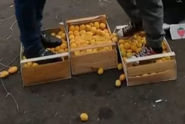 Azerbaijanis stomp apricots to protest against Armenia
