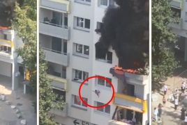 Crowd in France catches two kids jumping to escape apartment fire