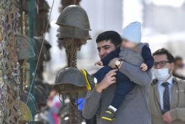 Azeris take their kids to play with helmets of fallen Armenian soldiers