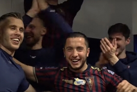 Pogon players cheer teammate Vahan Bichakhchyan for winning goal