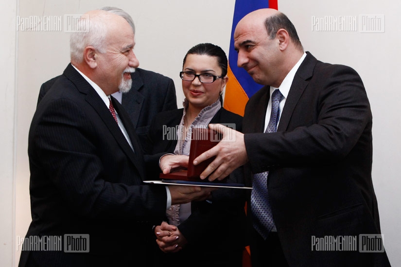 Armenian Minister of Energy and Natural Resources Armen Movsisyan presents medals to best workers of 2011