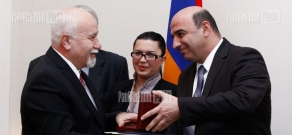 Armenian Minister of Energy and Natural Resources Armen Movsisyan presents medals to best workers of 2011