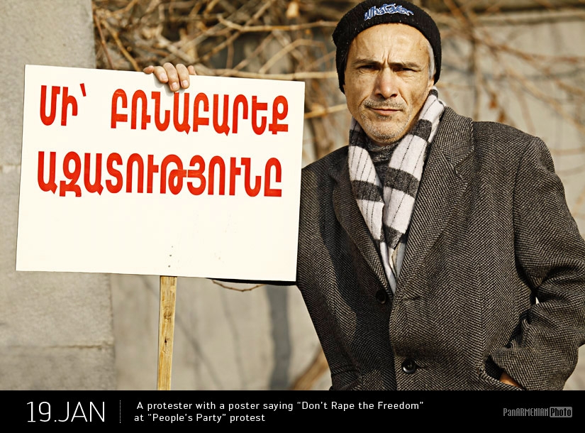 Протестующий с плакатом Не насиловать Свободу во время протеста Народной партии