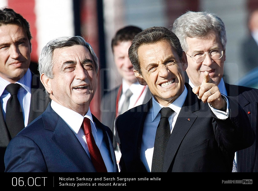French president Nicolas Sarkozy and Armenian president Serzh Sargsyan smile while Sarkozy points at mount Ararat