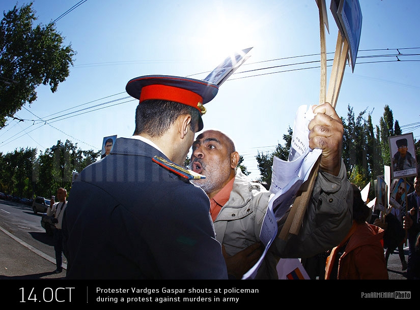 Protester Vardges Gaspar shouts at policeman during a protest against murders in Army
