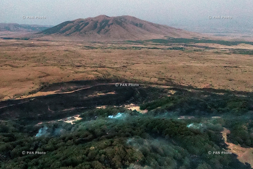 Fire rages in the vegetated area near the Armenian village of Byurakan