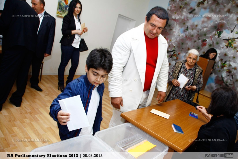 Prosperous Armenia leader Gagik Tsarukyan's son casting his father's vote  