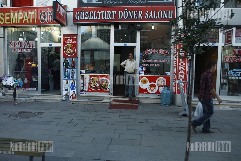 Typical Turkish street with small shops and bunch of ads