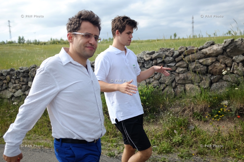 Magnus Carlsen and Levon Aronian play simul on 10 boards with monks and residents of Tatev
