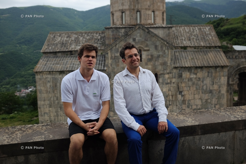 Magnus Carlsen and Levon Aronian play simul on 10 boards with monks and residents of Tatev