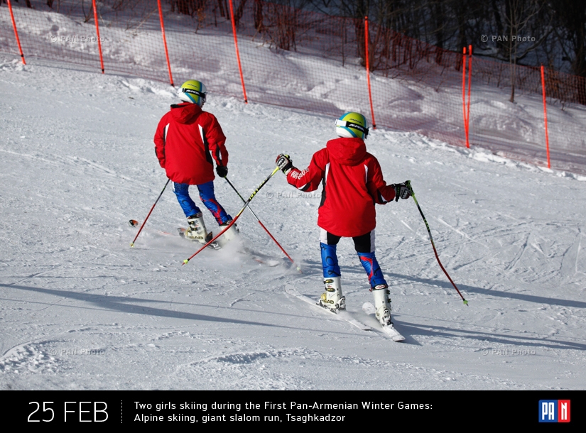 Two girls skiing during the First Pan-Armenian Winter Games: Alpine skiing, giant slalom run: Tsaghkadzor, Armenia