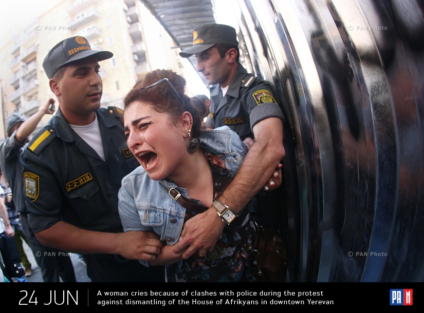 A woman cries because of clashes with police during the protest against dismantling of the House of Afrikyans in downtown Yerevan, Armenia