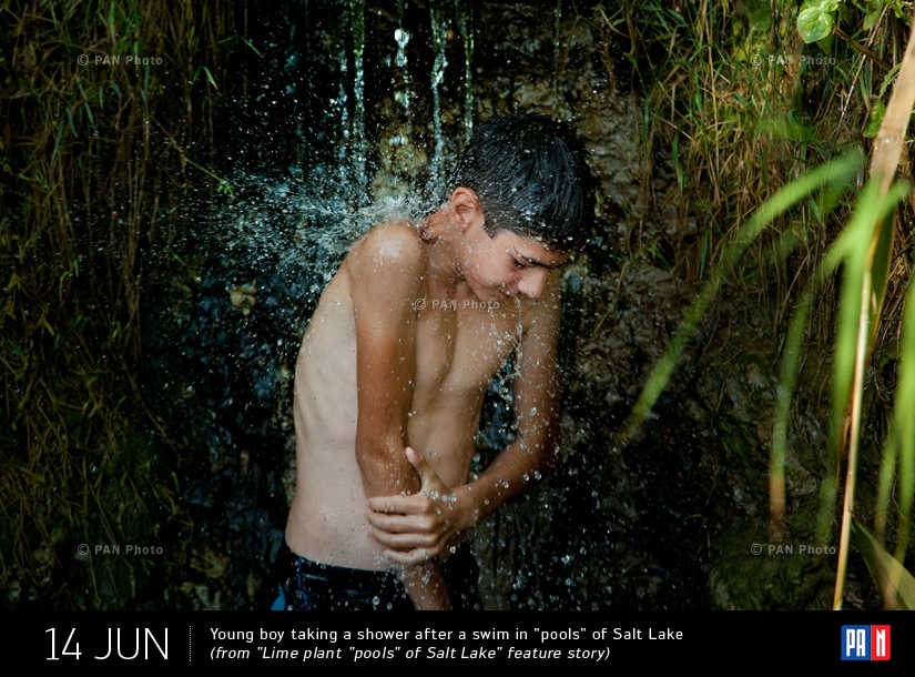 Young boy taking a shower after a swim in 