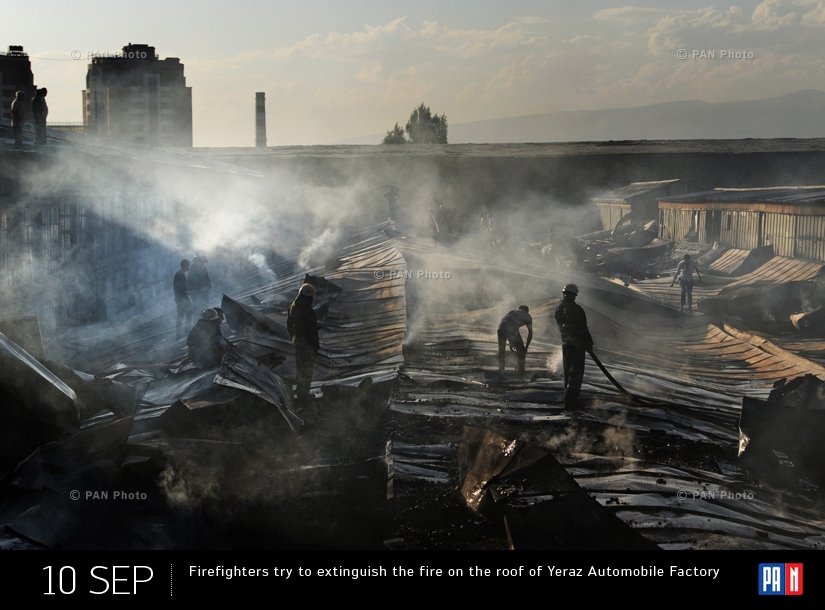 Firefighters try to extinguish the fire on the roof of Yeraz Automobile Factory. Yerevan, Armenia