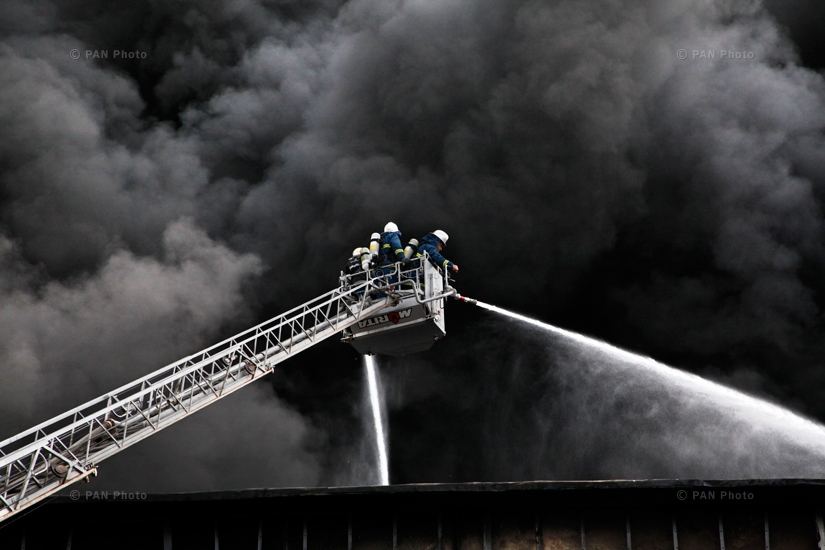 Firefighters try to extinguish the fire in Spayka LLC building. Yerevan, Armenia