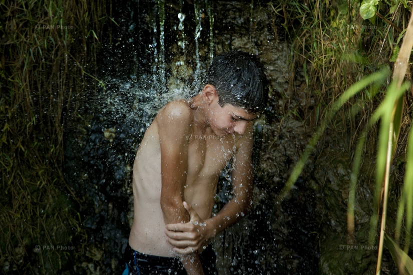 Young boy taking a shower after a swim in 